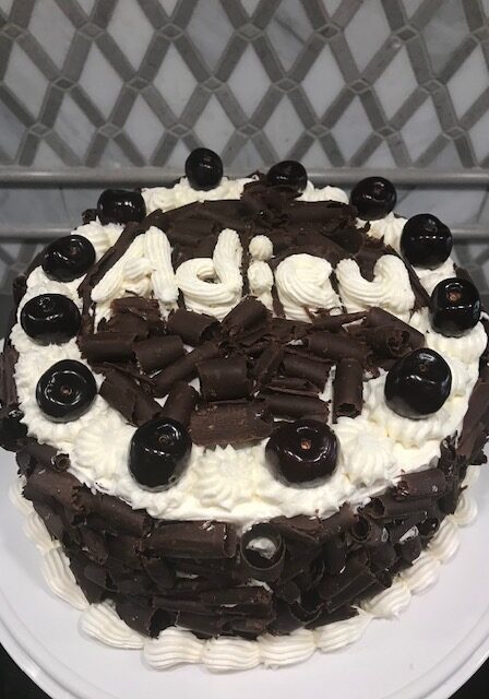 Black Forest Cake with the word Adieu on top.